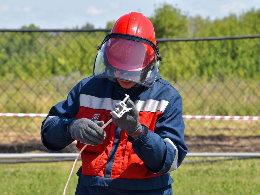 boy in red and black jacket wearing helmet